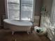 Bathroom featuring a clawfoot tub near a window, showcasing a vintage design at 14124 Plum Ln, Hudson, FL 34667