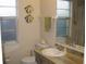 Cozy bathroom featuring a wood-look countertop, decorative fish, and a window for natural light at 1440 Hales Hollow Dr, Dunedin, FL 34698