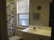 Bathroom with shower/tub combo and a single sink vanity at 1440 Hales Hollow Dr, Dunedin, FL 34698