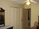 Bedroom with ceiling fan and closet space at 1440 Hales Hollow Dr, Dunedin, FL 34698