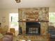 Living room featuring a stone fireplace at 1440 Hales Hollow Dr, Dunedin, FL 34698