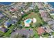 Aerial view of a community pool and clubhouse nestled in a residential area with tennis courts and ample parking at 1604 Mira Lago Cir, Ruskin, FL 33570