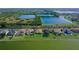 Aerial view of homes with well-kept lawns and lake views in a serene community setting at 1604 Mira Lago Cir, Ruskin, FL 33570