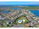 Aerial view of a Gathering-friendly community with a community pool, mature trees, ponds, and well-kept homes at 1604 Mira Lago Cir, Ruskin, FL 33570