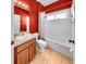 Red bathroom with tile flooring, a single sink vanity and tub/shower combo at 1604 Mira Lago Cir, Ruskin, FL 33570