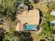 Aerial view of home with screened-in pool and well-maintained landscaping at 18836 Autumn Lake Blvd, Hudson, FL 34667