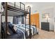 Bedroom with bunk beds featuring blue striped bedding, closet, dresser and ample natural light from the window at 18836 Autumn Lake Blvd, Hudson, FL 34667