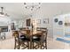 A cozy dining room features a dark wood table under a stylish chandelier at 18836 Autumn Lake Blvd, Hudson, FL 34667