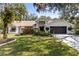 Charming single Gathering home with landscaped lawn, manicured shrubs and two car garage at 18836 Autumn Lake Blvd, Hudson, FL 34667