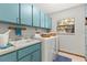 Bright laundry room featuring a utility sink, cabinets, and a window at 18836 Autumn Lake Blvd, Hudson, FL 34667