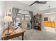 Bright home office with wooden desk, shelving, and sliding glass doors to the pool area at 18836 Autumn Lake Blvd, Hudson, FL 34667