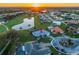 Aerial view of a home in a residential community with a pond, a golf course, and well-maintained landscaping at 2011 Captiva Ct, Sun City Center, FL 33573