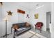 Neutral bedroom featuring a futon, wicker chair, and colorful wall art at 2011 Captiva Ct, Sun City Center, FL 33573