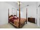 Bedroom with a canopy bed, carpet, and a wooden dresser at 2011 Captiva Ct, Sun City Center, FL 33573