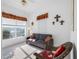 Neutral bedroom featuring a futon, wicker chair, and bright natural light at 2011 Captiva Ct, Sun City Center, FL 33573