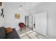 Bedroom featuring a futon, wicker chair, wardrobe, and colorful wall art at 2011 Captiva Ct, Sun City Center, FL 33573