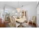 Formal dining room with mirrored wall and modern chandelier at 2011 Captiva Ct, Sun City Center, FL 33573