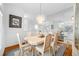 Dining room with mirrored wall, chandelier, and view into the kitchen at 2011 Captiva Ct, Sun City Center, FL 33573