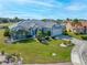 Landscaped single-story home with a gray tile roof, manicured lawn, and an attached two-car garage at 2011 Captiva Ct, Sun City Center, FL 33573