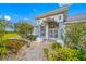 Charming home entrance with landscaped walkway and decorative front door at 2011 Captiva Ct, Sun City Center, FL 33573