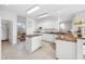 Spacious kitchen featuring white cabinets, granite countertops, and an island at 2011 Captiva Ct, Sun City Center, FL 33573