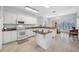 Bright kitchen with white cabinets, granite countertops, and stainless steel appliances at 2011 Captiva Ct, Sun City Center, FL 33573