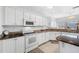 Kitchen featuring granite countertops, white cabinets, and modern appliances at 2011 Captiva Ct, Sun City Center, FL 33573