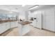 Spacious kitchen featuring white cabinets, granite countertops, and an island at 2011 Captiva Ct, Sun City Center, FL 33573