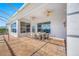 Covered patio area with a dining set, ceiling fans, and textured concrete flooring at 2011 Captiva Ct, Sun City Center, FL 33573