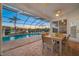 The screened patio features a dining table and chairs, overlooking the pool and water feature at 2011 Captiva Ct, Sun City Center, FL 33573