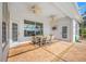 A covered patio with a dining set, ceiling fans, and access to the pool area at 2011 Captiva Ct, Sun City Center, FL 33573