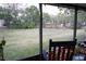 A view of the backyard from a screened porch with furniture at 2025 Grantham Greens Dr # 52, Sun City Center, FL 33573