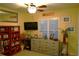 Bright bedroom features a large window, dresser and stylish decor at 2025 Grantham Greens Dr # 52, Sun City Center, FL 33573