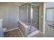 Modern glass-enclosed shower and toilet in a bright and spacious bathroom at 204 El Prado, North Port, FL 34287