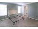 This bedroom has carpet and a headboard with a metal bedframe and an open door at 204 El Prado, North Port, FL 34287