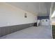 Covered carport with a concrete floor, steps to a back door, and a separate storage room at 204 El Prado, North Port, FL 34287