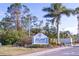 Welcoming community entrance sign with lush landscaping and a well-maintained road at 204 El Prado, North Port, FL 34287