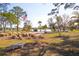 Scenic community park with an American flag waving near a tranquil lake and lush landscaping at 204 El Prado, North Port, FL 34287