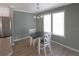 Dining area features a table, chairs, windows, and a modern chandelier at 204 El Prado, North Port, FL 34287