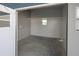 A small shed providing extra storage space, featuring a window for natural light and a concrete floor at 204 El Prado, North Port, FL 34287