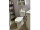 Cozy bathroom features a toilet, storage cabinet, and linen shelving at 2330 Ecuadorian Way # 10, Clearwater, FL 33763