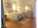 Bright bedroom featuring a floral bedspread, light wood furniture, and art evoking a seaside retreat at 2330 Ecuadorian Way # 10, Clearwater, FL 33763