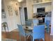 Bright dining area with a glass table, blue chairs, and natural light at 2330 Ecuadorian Way # 10, Clearwater, FL 33763