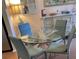 Bright dining area with a glass table, blue chairs, and stylish decor at 2330 Ecuadorian Way # 10, Clearwater, FL 33763