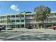 Multi-story building featuring balconies and well-maintained landscaping at 2330 Ecuadorian Way # 10, Clearwater, FL 33763