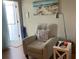 Comfortable armchair in a cozy living room with beach-themed decor and plenty of natural light at 2330 Ecuadorian Way # 10, Clearwater, FL 33763