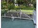 Inviting patio area with a white picket fence and lush greenery at 2330 Ecuadorian Way # 10, Clearwater, FL 33763