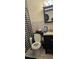 Bathroom featuring a toilet, cabinet, vanity, sink, and shower with checkered curtain at 2414 E 8Th Ave, Tampa, FL 33605