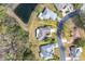 Aerial view of property lines showcasing home with pond and lush landscaping at 29447 Schinnecock Hills Ln, San Antonio, FL 33576