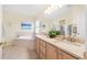 Bright bathroom features a double vanity, garden tub and glass shower with natural light at 29447 Schinnecock Hills Ln, San Antonio, FL 33576